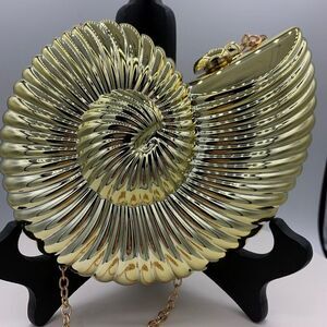 New, no tags, hard acrylic clamshell, clutch purse, mirror gold, fully lined